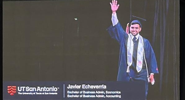 Javier Echeverria waving from the screen at his UTSA graduation ceremony